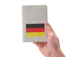 German passport in a man's hand on white background