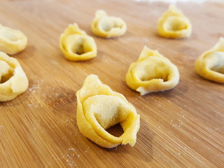 Home made tortellini on wood surface