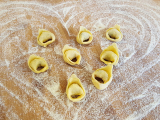 Home made tortellini on wood surface