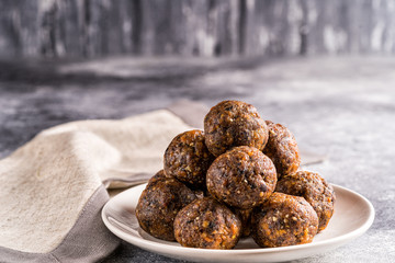 Fruit and nut energy balls on a plate, selective focus..