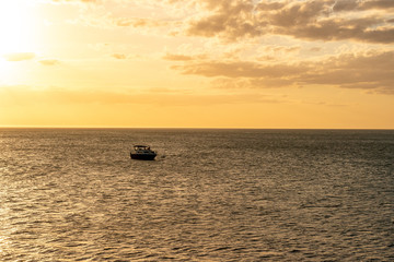 Naklejka na ściany i meble fishing boat at sunset