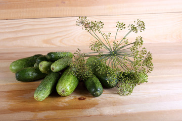 Cucumbers and dill on table