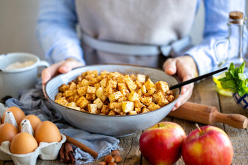 ale filling with cinnamon and raisins for strudel.Cooking strudel.Cooking apple pie at home. Sliced ​​apples in a bowl with cinnamon and sugar.Cooking together at home. Ingredients for the pie. 
