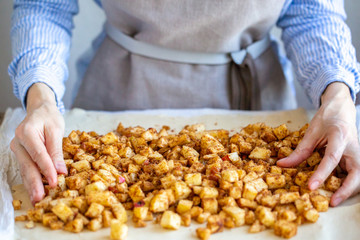 Apple filling with cinnamon and raisins for strudel. Cooking strudel. Cooking apple pie at home. Sliced ​​apples with cinnamon and sugar. Put the filling on the dough. Ingredients for the pie.
