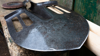 a black sharpened shovel. attachment to the stalk