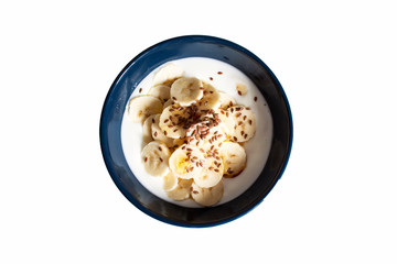 Yogurt with bananas, flax seeds and honey isolated on white background