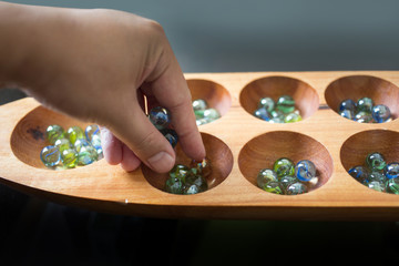 hand hold glass ball in kalaha game