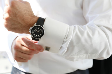 businessman holding clock