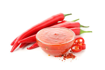 Chilli pepper and bowl of sauce isolated on white background