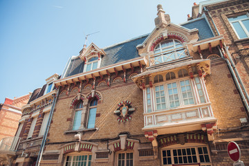Fototapeta premium DUNKIRK, FRANCE - AUGUST 2019: Traditional Brick built French Terraced Seaside Houses with their Colors weathered by the elements, facing the beach at Dunkirk in France