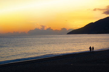 Fototapeta premium Gorgeous Sunny sunset on the sea with silhouettes of people. Relaxation and peace. The slow life.