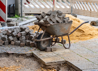 Baustelle im Wegebau Pflastersteine Schubkarre