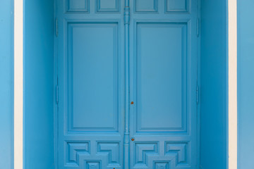 Blue painted door with white details on side