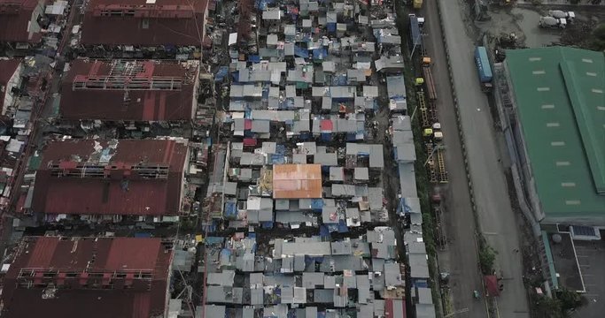 Straight aerial flight over poor squatter area then descending, Tondo, Manila, Philippines