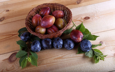 Different color plums on table