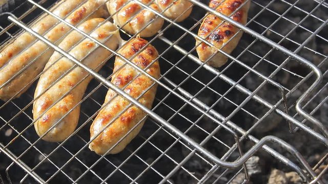Kupaty sausages on a grill. Kupaty was made from chicken and pork, intestines, pepper, onions and other spices. Stay home with family and cook barbecue during May holidays and the coronavirus pandemic