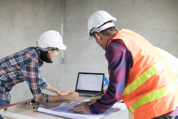 Engineer and worker planning for construction building and renovate in working site