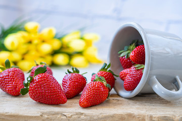 Strawberries in an iron mask. Fresh strawberries on a wooden table. Strawberry juice. strawberries on a natural background.