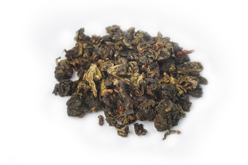 Slide of green tea leaves isolated against white macro background