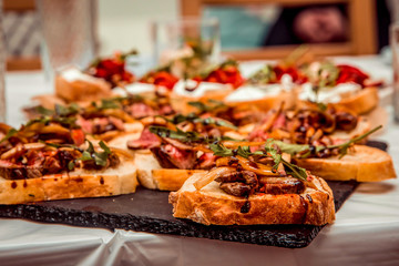 sandwiches with roast beef meat on a black plate