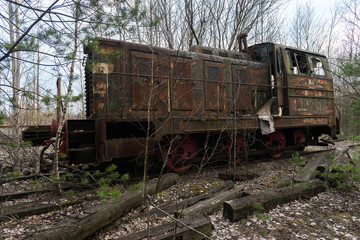 Fototapeta na wymiar Old radioactive locomotion at abandoned station Yanov near ghost town Pripyat