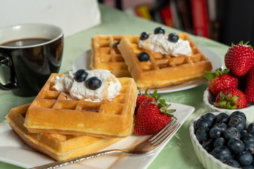 Belgian waffles on plate with fruit
