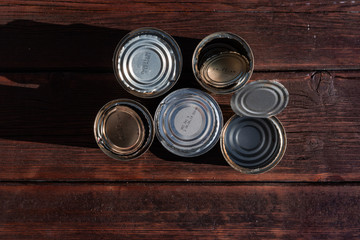 Fototapeta premium old empty cans on a wooden table, brown wooden background