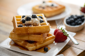Belgian waffles on plate with fruit