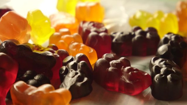 Hand pick up jelly bears. Gummy candies