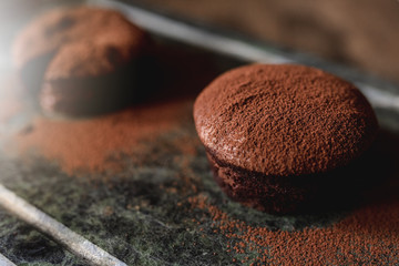 Close up of chocolate cake with fondant heart and cocoa powder as decoration for the dessert.