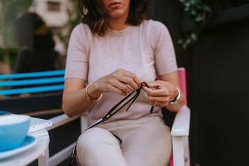 Fototapeta premium A beautiful young caucasian woman puts on a mask. COVID - 19 protection