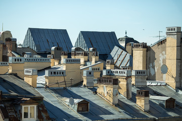 Fototapeta premium View at the top of the roofs. Blue sky and old roof of ancient city