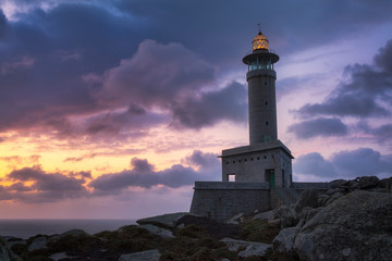 Fototapeta na wymiar Punta Nariga Lighthouse at sunset in Malpica, Galicia, Spain