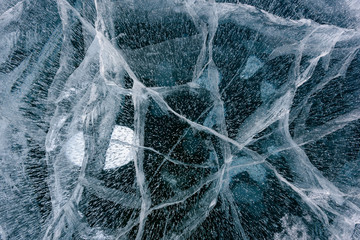 Beautiful ice of Lake Baikal with abstract cracks