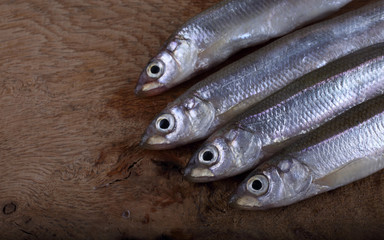 Smelt fish on cutting board