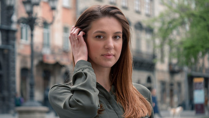 Outdoor close up portrait of young beautiful fashionable woman