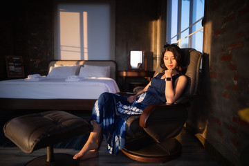Fototapeta na wymiar Beautiful Asian woman sitting on chair in the room.