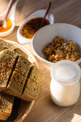 Milk, cereals and bread in breakfast set.