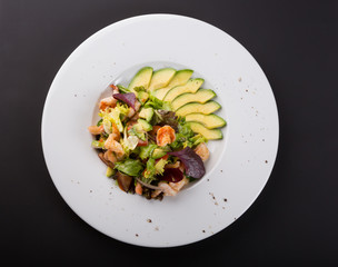 Avocado and shrimp salad in a white bowl plate