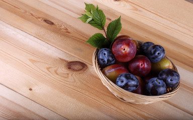 Different color plums on table