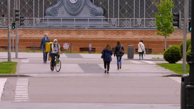 Madrid / Spain-04/19/20 Pedestrians crossing a crosswalk at the Atocha station during confinement in April 2020. Covid 19, coronavirus spain