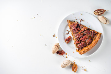 Homemade autumn pecan pie on white background, Traditional fall and winter, thanksgiving american nut cake,