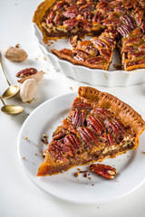 Homemade autumn pecan pie on white background, Traditional fall and winter, thanksgiving american nut cake,