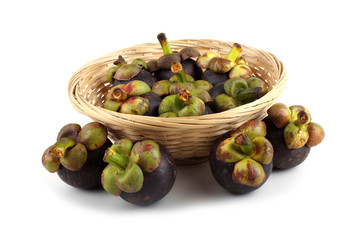 Mangosteen fruits on wicker plate