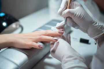 closeup shot and manicure artist making nail cleaning and polishing