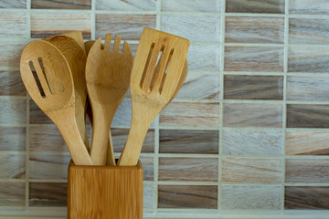 Wooden spoons in wicker basket 