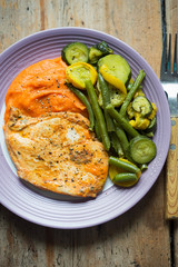 Grilled chicken breast with carrot potato puree, courgette and beans