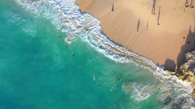 Beach scene - turquoise transparent ocean and  white sand beach. Bali, Dreamland beach, aerial 4k footage.