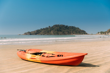 Fototapeta na wymiar Canacona, Goa, India. Canoe Kayak For Rent Parked On Famous Palolem Beach In Summer Sunny Day