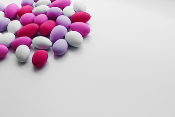 Colorful chocolate еgg-shaped candy for backgrounds. Flat lay.